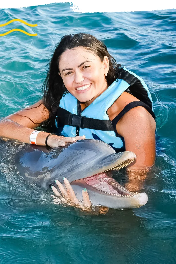 Smiling woman with a dolphin