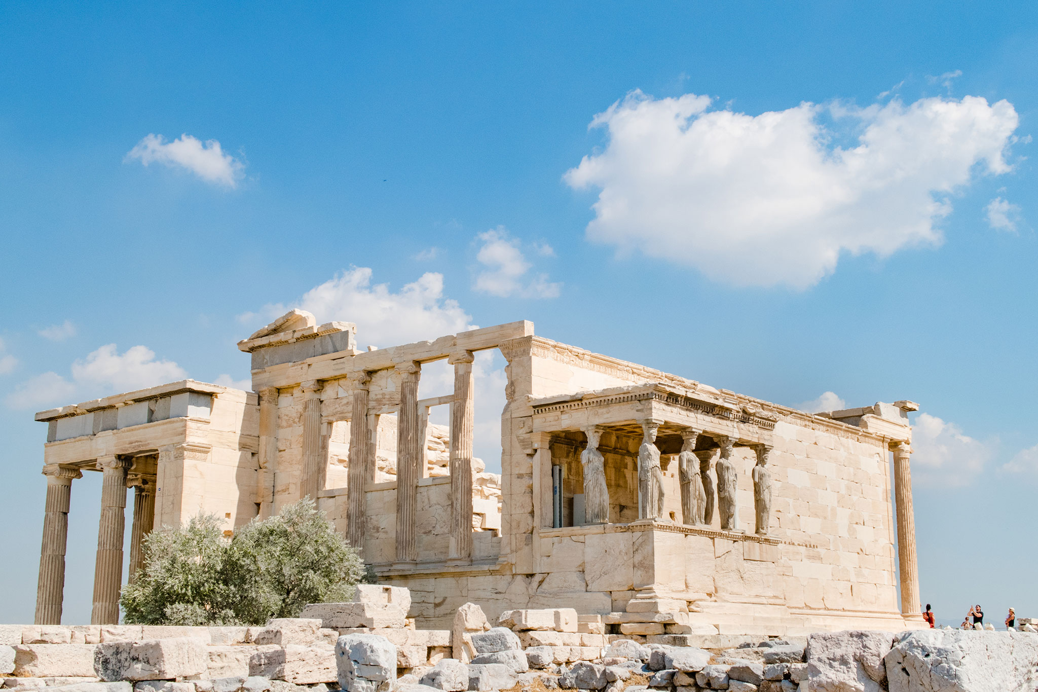 A view of the Erechtheion at the Acropolis, with its intricate marble columns and caryatid statues holding up the temple’s southern porch.
