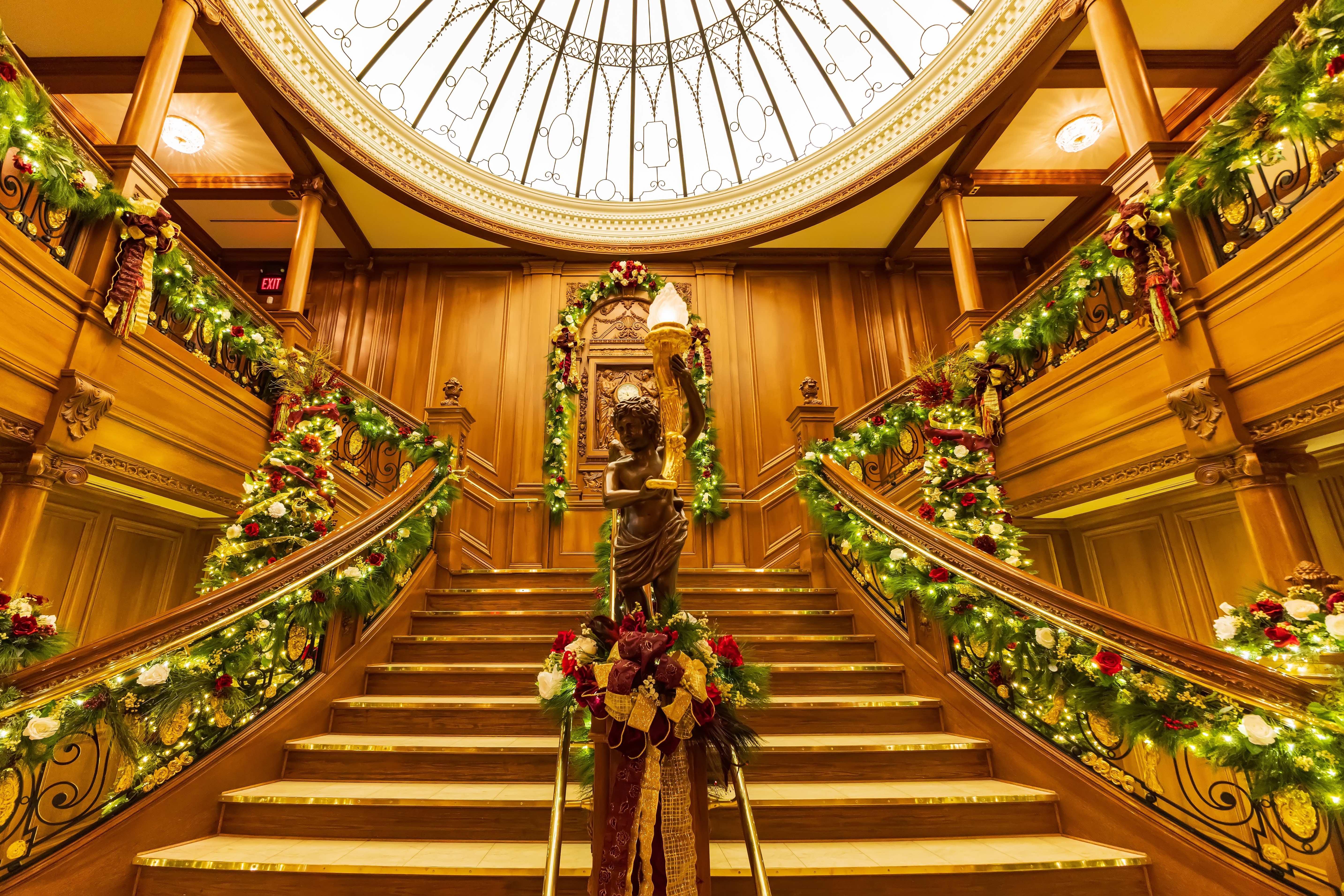 Grand golden staircase decorated with Christmas garlands int the Titanic Museum in Branson, Missouri