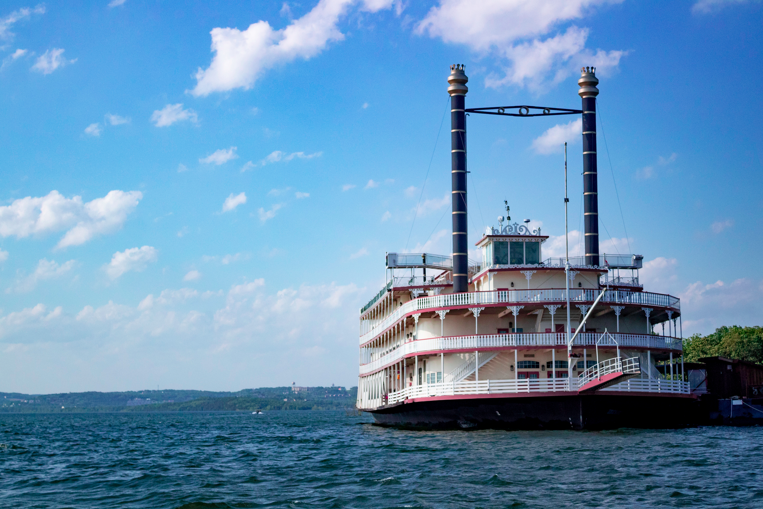 A red and white ferry boat on the blue waters of Table Rock Lake in Branson, Missouri