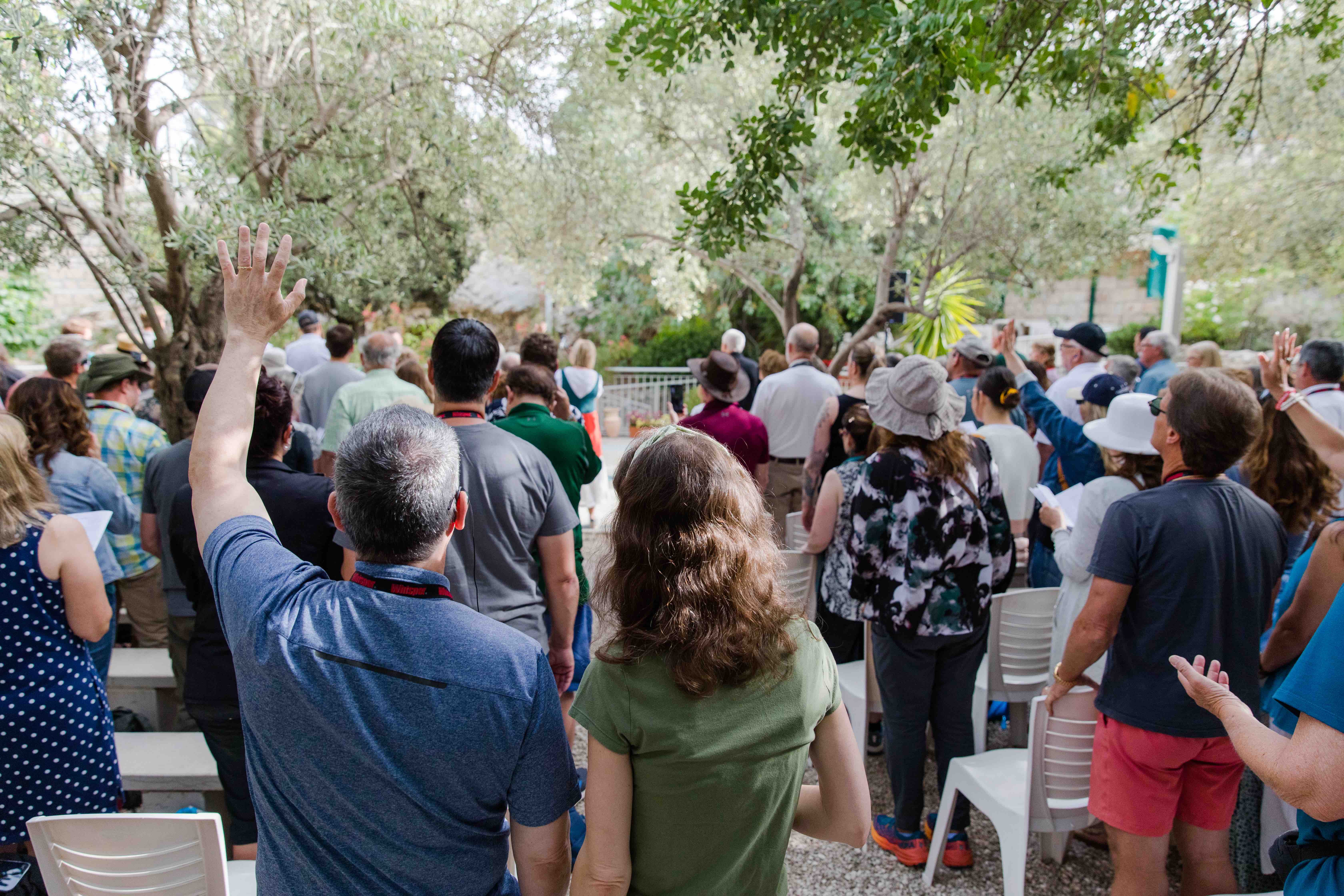 Group worshiping in the Garden of Gethsemane