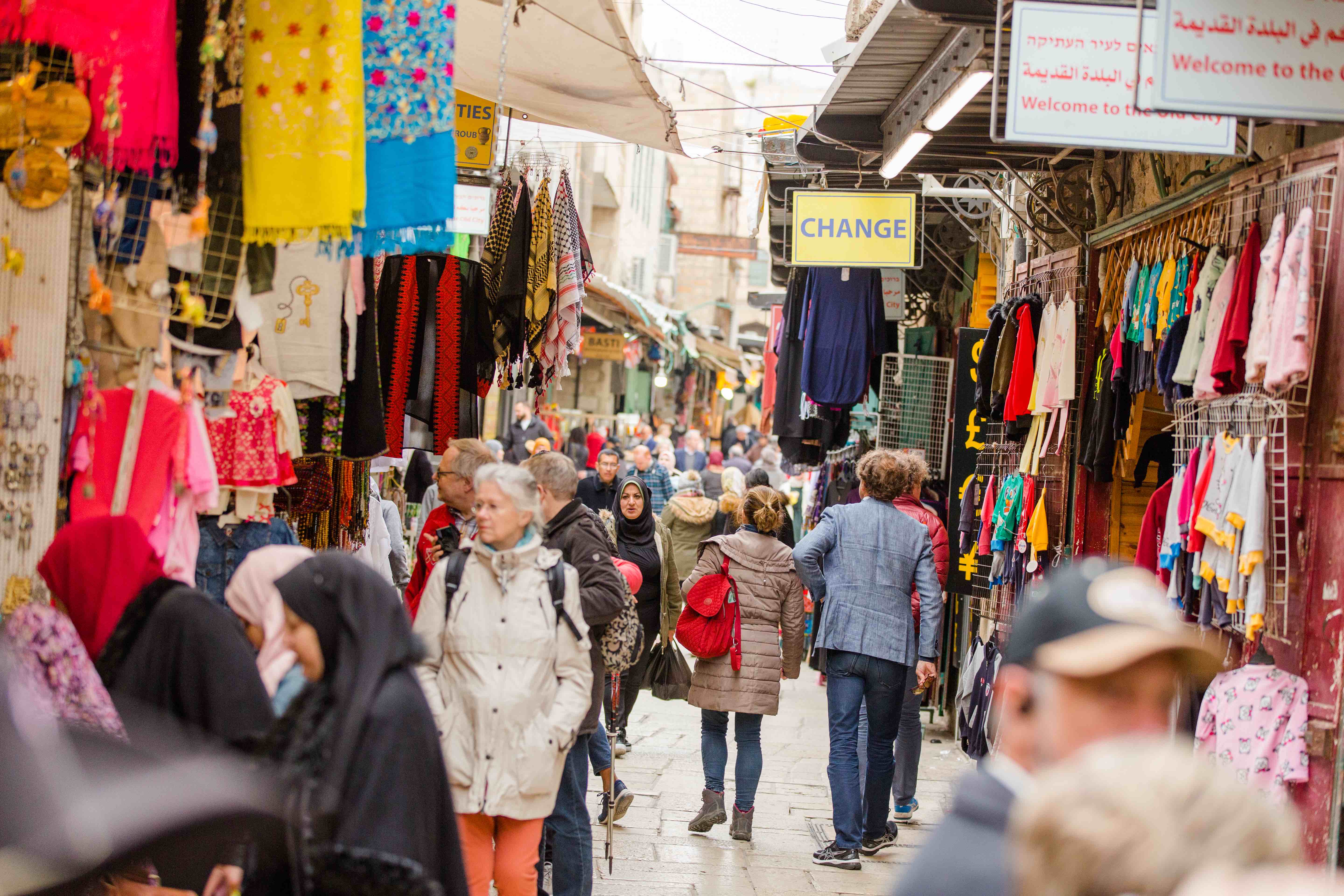Shoppers of different ethnicities walking around the Arab Souk in Old City Jerusalem.
