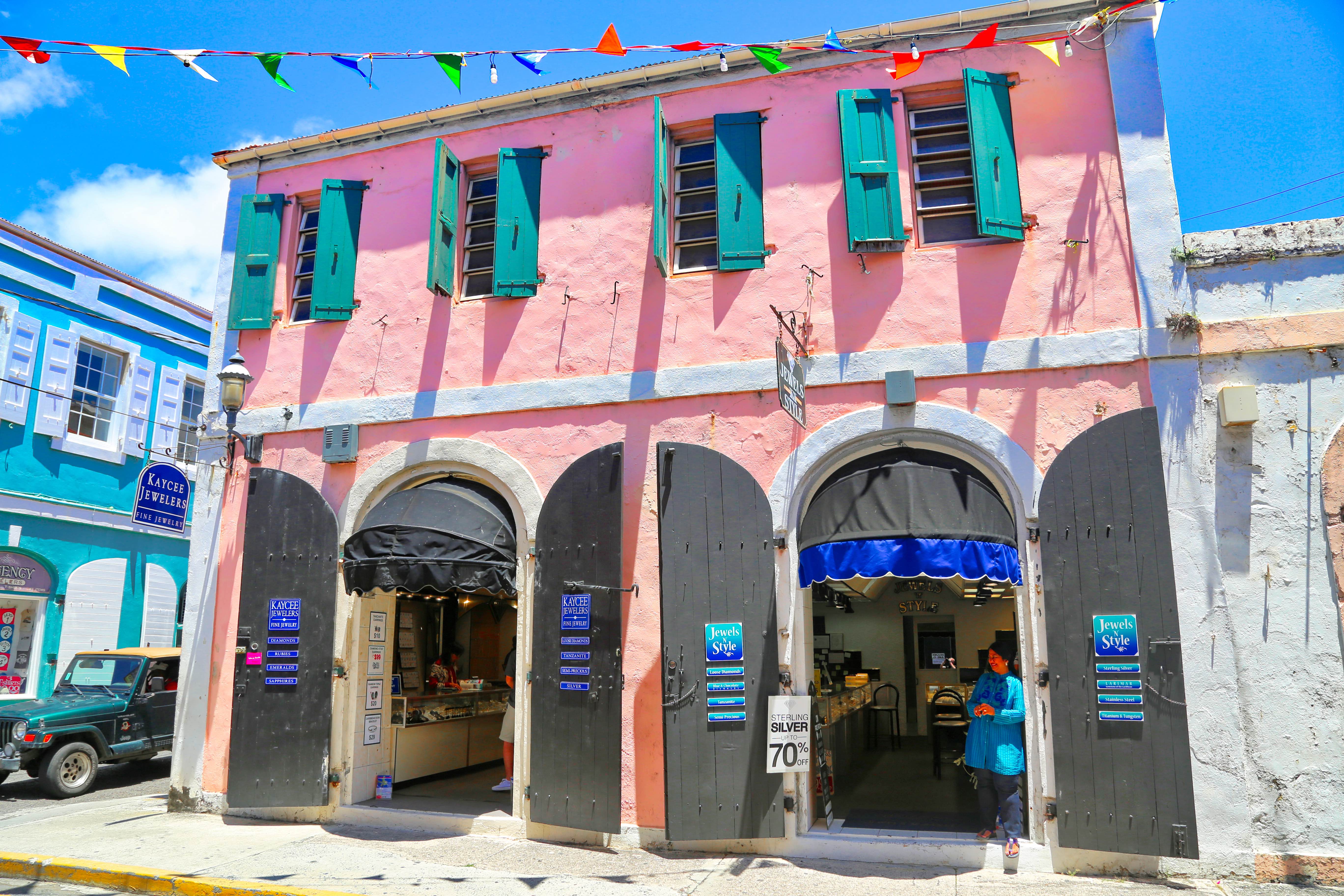 Tourist stops for souvenirs in pink storefront in the historic district of Charlotte Amalie, St. Thomas